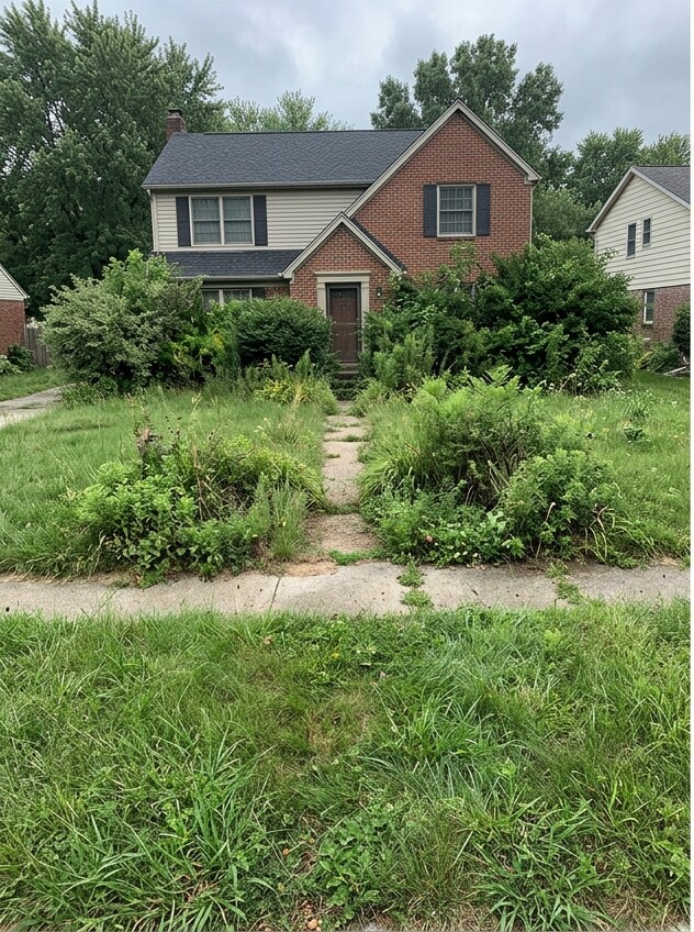 Front yard before landscape work, with overgrown lawn and garden beds